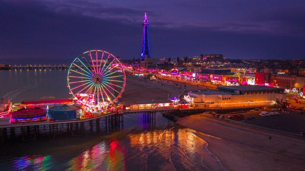In this aerial view Blackpool's Central Pier is illuminated by the lights of the funfair as visitors to Lightpool 2025 arrive for the opening night on October 15, 2025 in Blackpool, England.