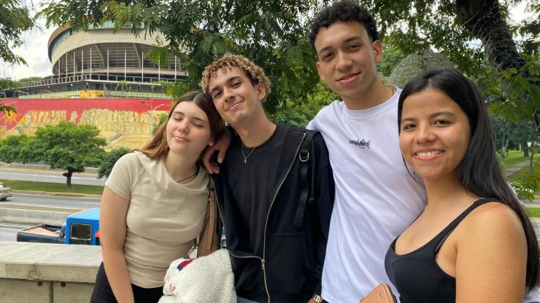 Four young people pose for a photo.