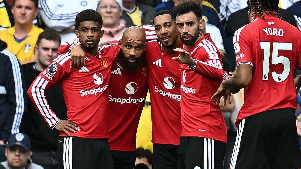 Manchester United striker Bryan Mbeumo in a huddle with several team-mates