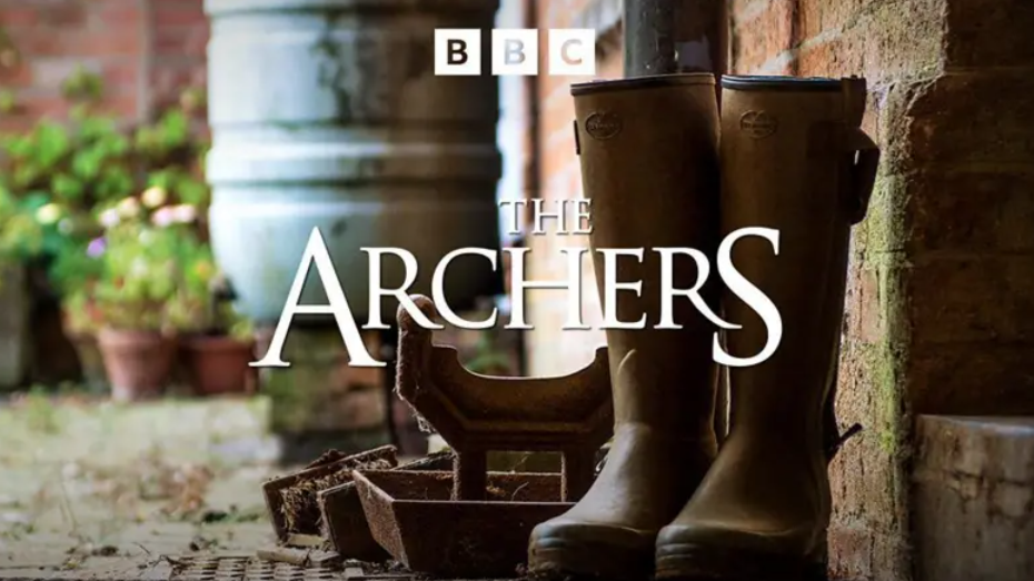 A photo of wellies with a white writing which says THE ARCHERS.