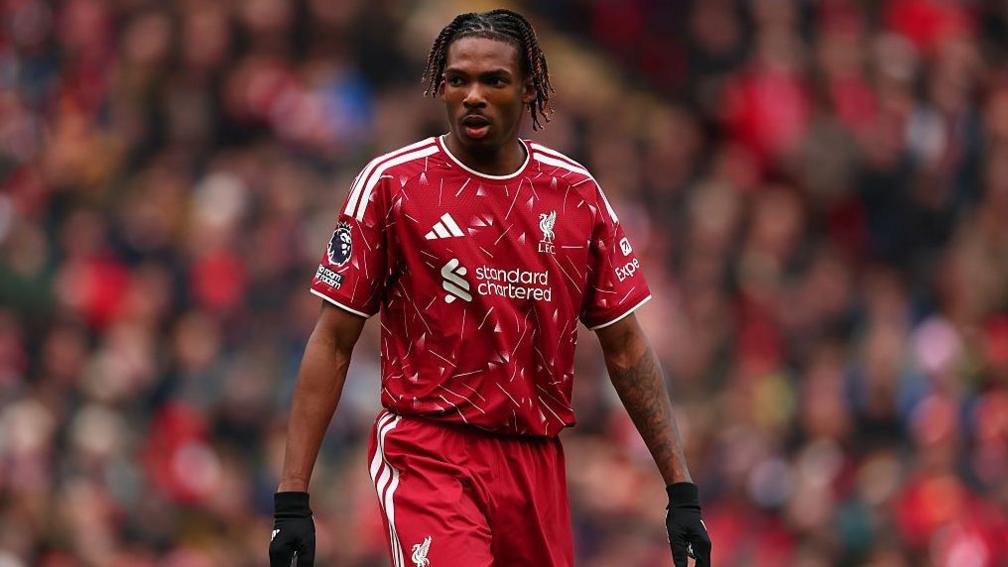 Jeremy Jacquet in Liverpool kit with a blurred crowd behind him