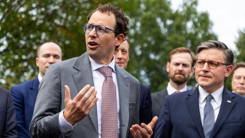Co-founder of Anthropic Dario Amodei (L) responds to a question from the news media outside the West Wing of the White House