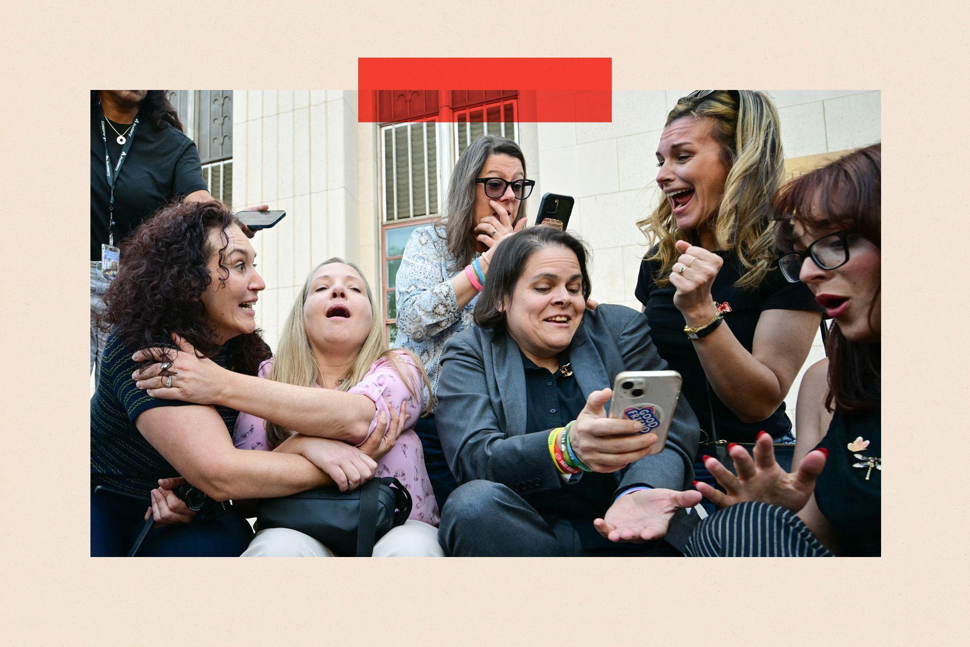 Laura Marquez-Garrett (3R, gray blazer), plaintiffs' attorney for SMVLC (Social Media Victims Law Center), gathers with family members of victims as they react to news that the jury has found Meta and YouTube liable in the social media addiction trial, outside the Los Angeles Superior Court , in Los Angeles, on March 25, 2026.
