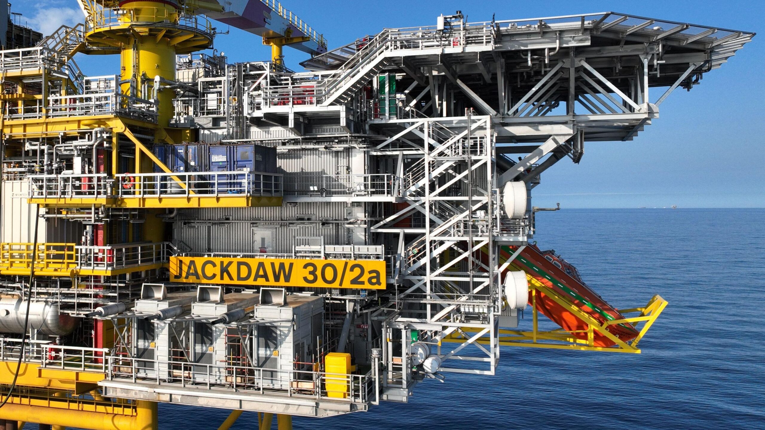 The Jackdaw platform in the North Sea, a grey and yellow metal structure with a yellow sign reading Jackdaw 30/2a
