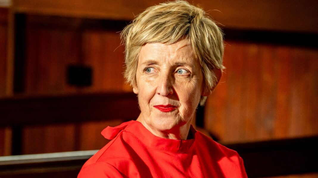 Julie Hesmondhalgh left Celebrity Traitors ‘with head held high’ Julie Hesmondhalgh, with short blonde hair, wears a high-collared red dress and looks over her shoulder