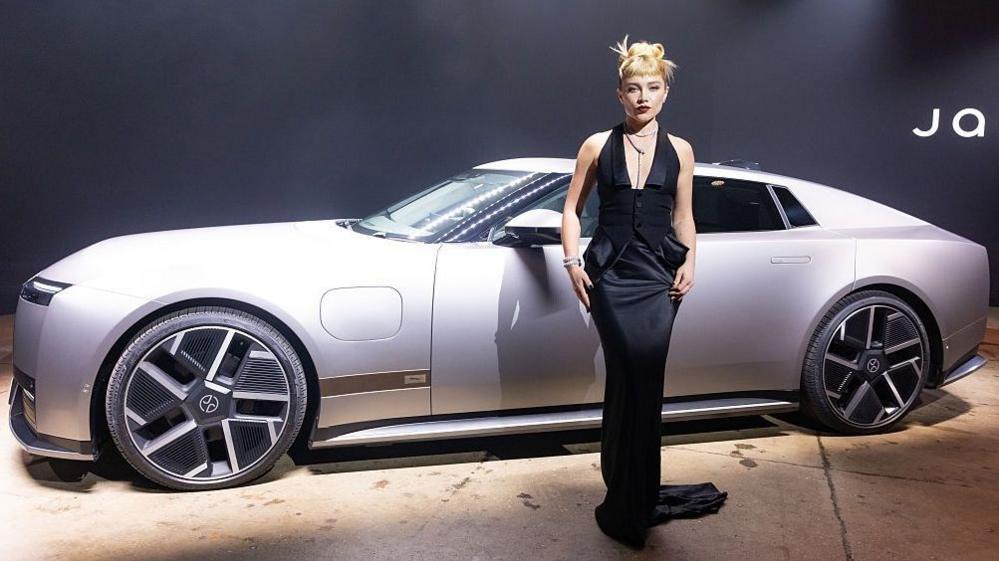Florence Pugh poses next to a Jaguar Type 01 during the car's launch event at Storied NYC on October 06, 2026 in New York City.