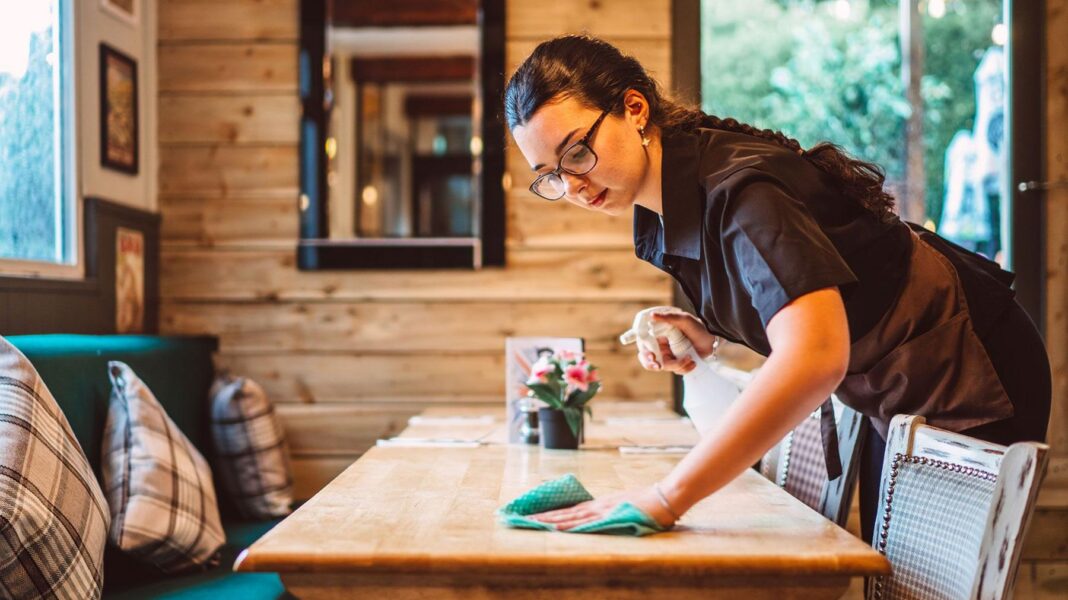 What the Budget offers for under 25s – and what it leaves out A young women working in a cafe wipes down a wooden table with a green cloth