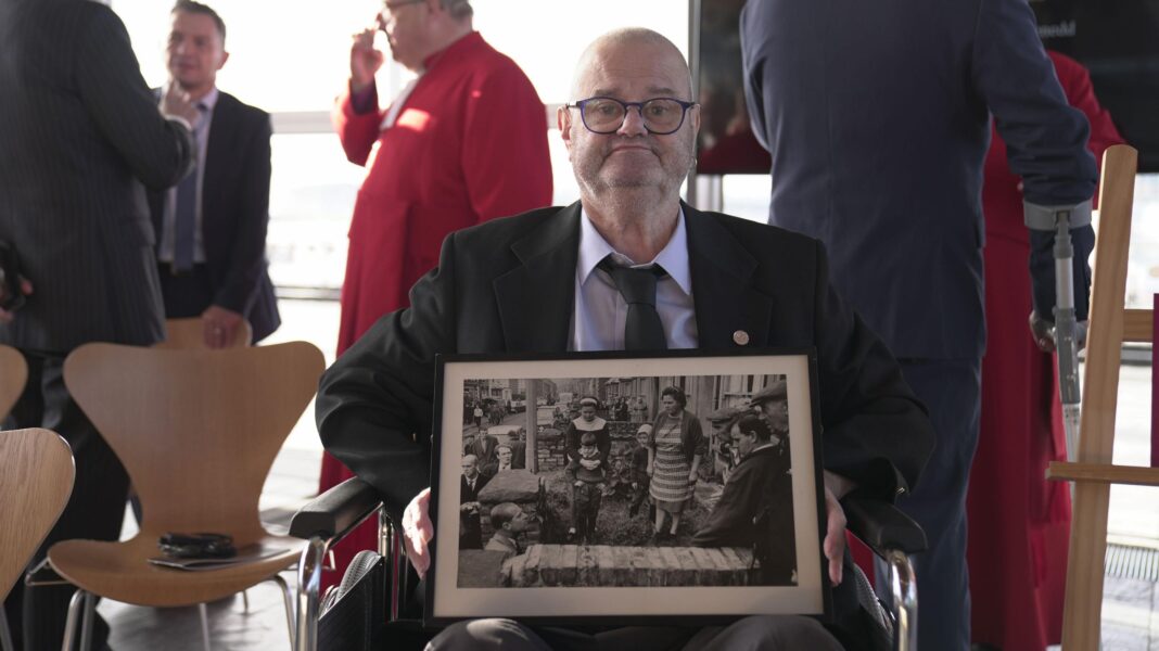 King Charles praises Welsh ‘sense of belonging’ as he opens Senedd Gareth Jones holding a black and white picture of the King's father meeting him and his sister after the Aberfan disaster.