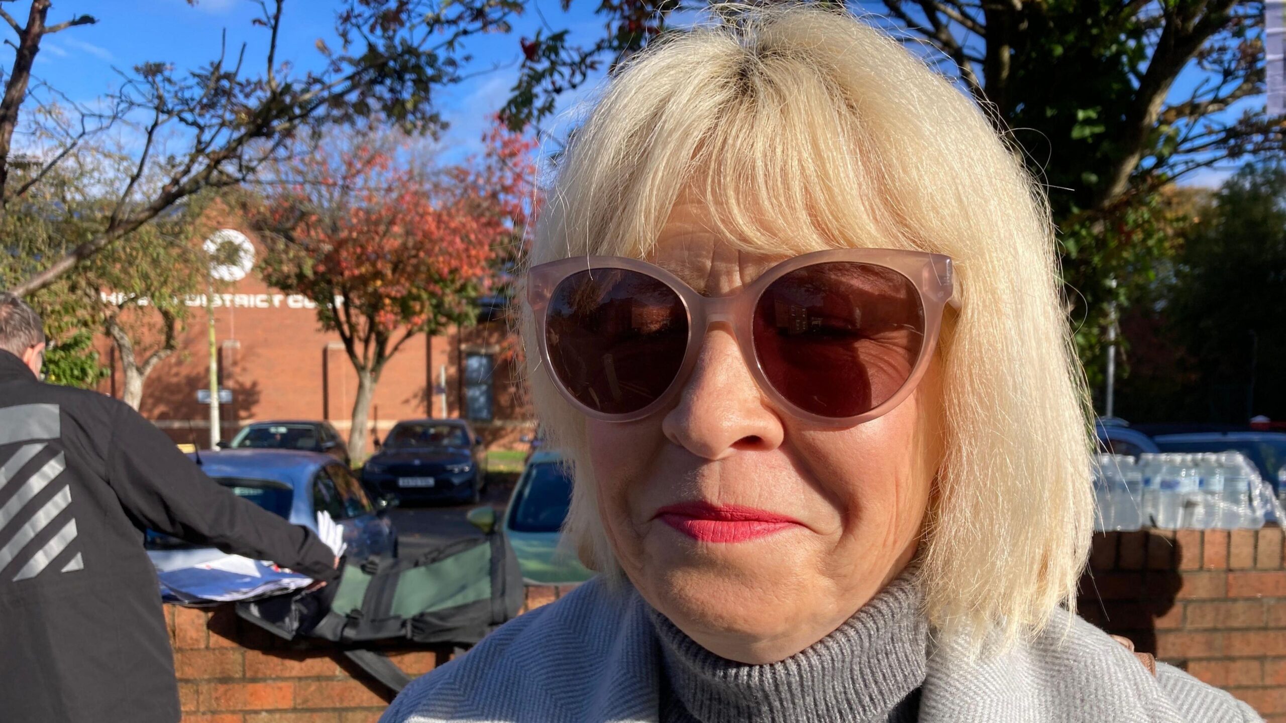 A woman with blonde hair and sunglasses