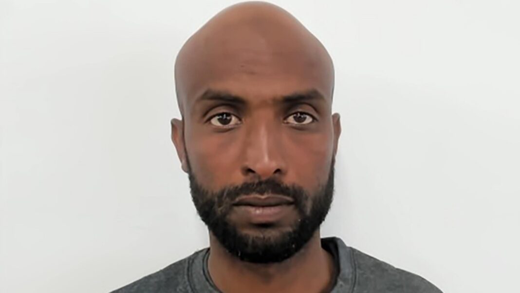 Man jailed for piloting small boat carrying 26 others Mugshot photo of a man with a bald head, beard and grey jumper. He is looking at the camera.