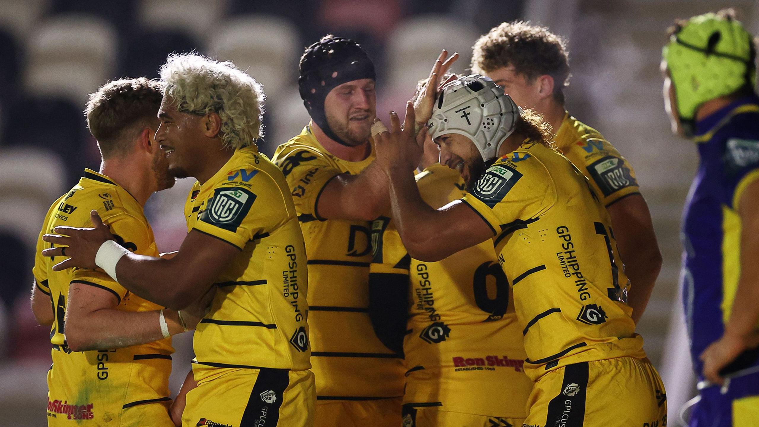 Dragons celebrate Anzelo Tuitavuki's try against Zebre