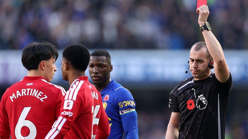 Manchester United defender Lisandro Martinez is shown a red card by referee Peter Bankes