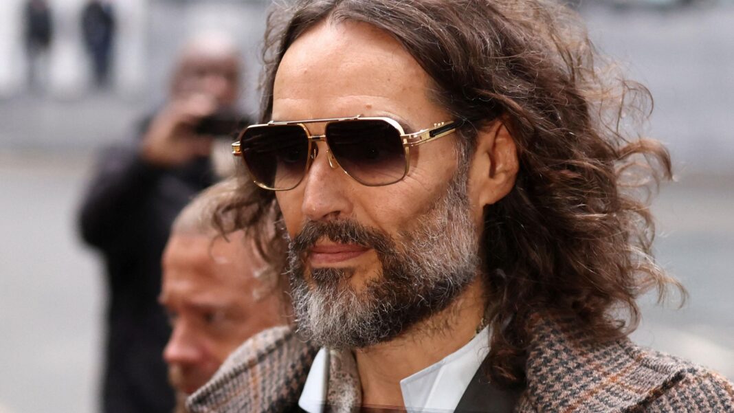 Russell Brand arriving at court on Wednesday wearing sunglasses and a tweed jacket