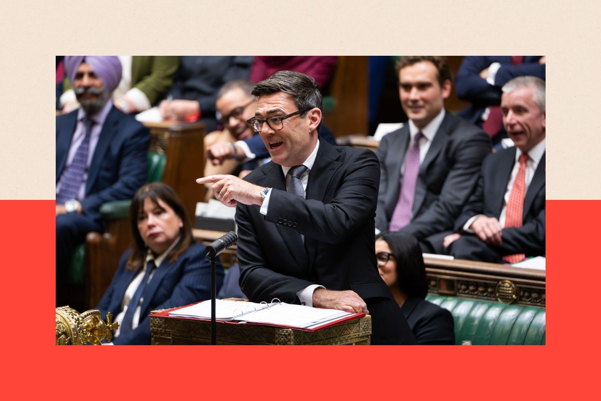Andy Burnham in a black suit speaking at parliament and doing a pointing motion with his hand as he addresses MPs.