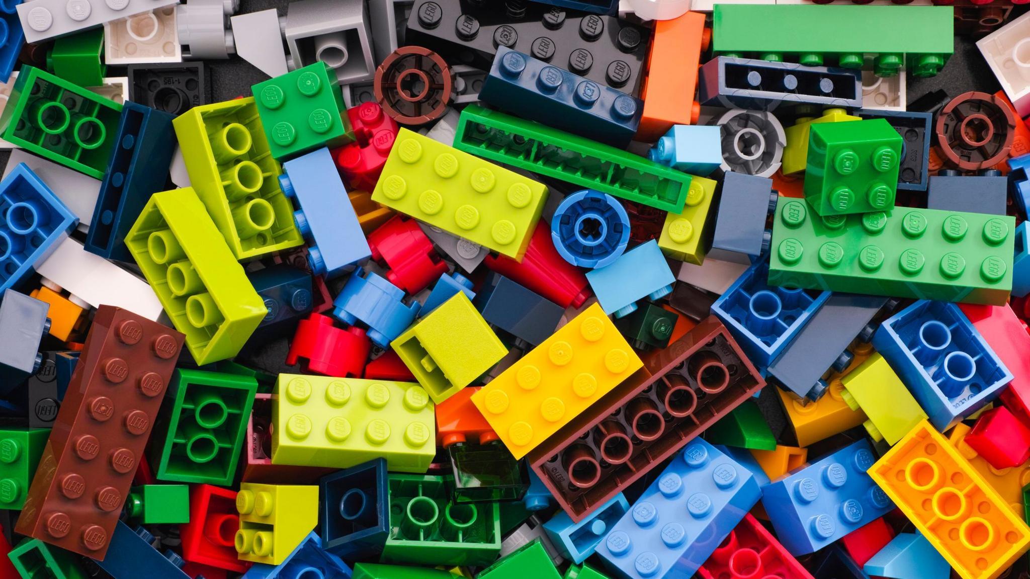 A pile of randomly assorted Lego pieces of all shapes and colours