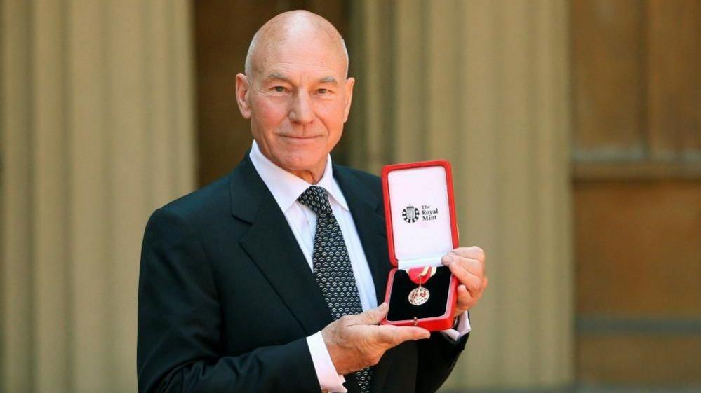 Sir Patrick poses with his knighthood medal