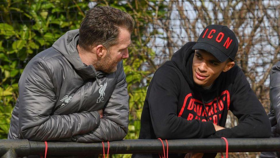Former Liverpool player Trent Alexander-Arnold chatting with academy director Alex Inglethorpe
