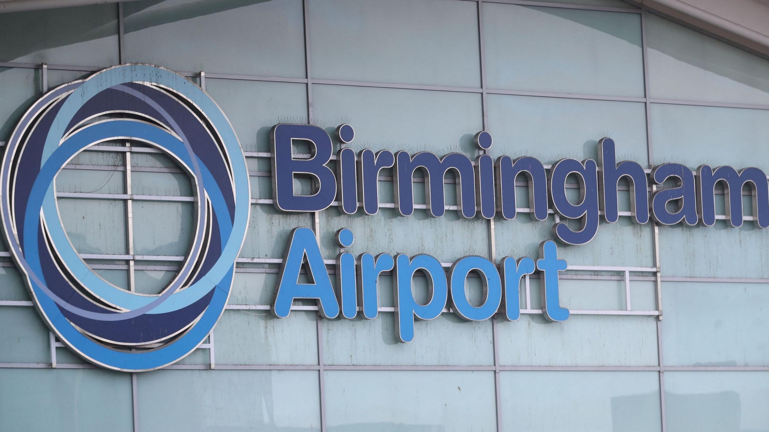 The Birmingham Airport sign in two shades of blue against a lighter background.