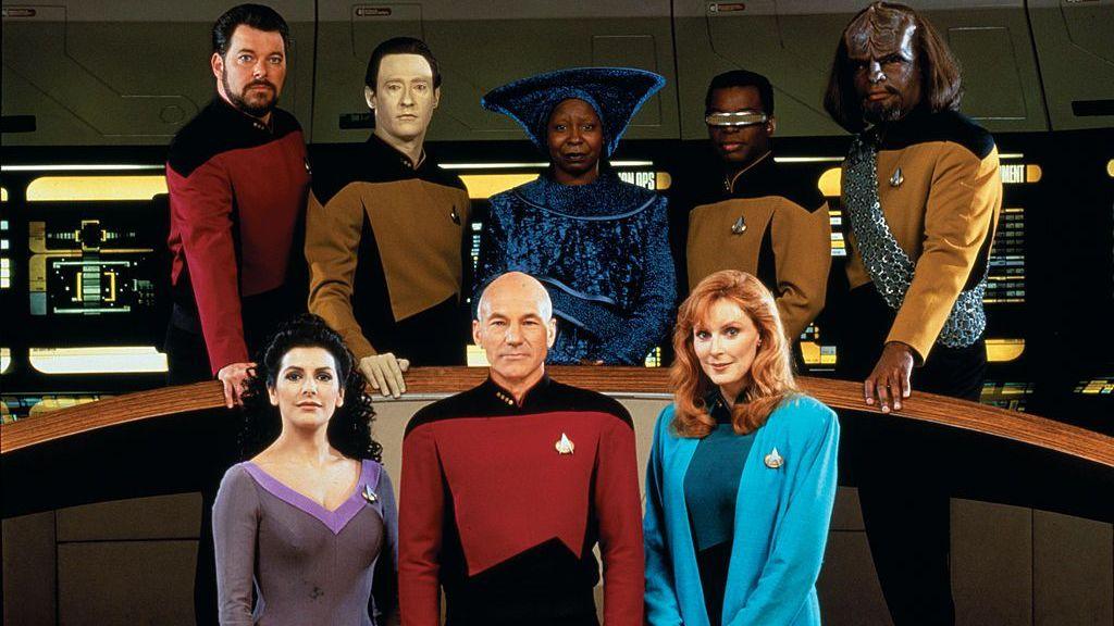 The cast of Star Trek: The Next Generation poses for a photo inside a spaceship
