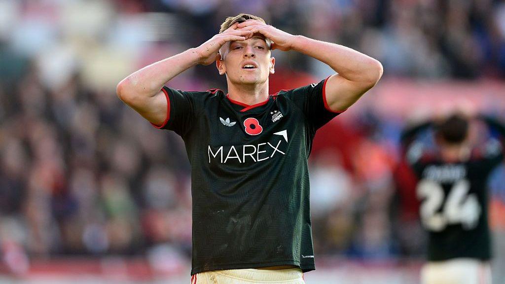 Liam Delap with his hands on his forehead looking disappointed