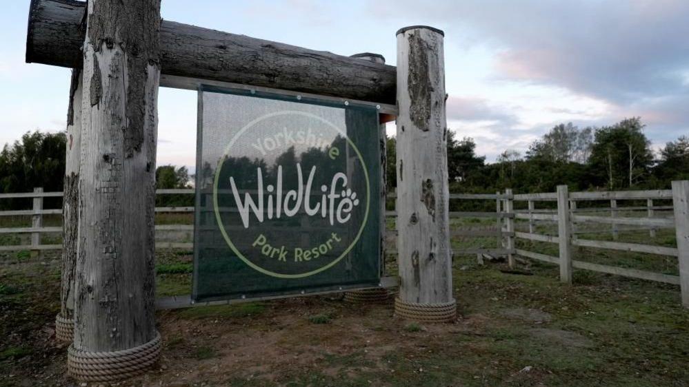 Yorkshire Wildlife Park sign with wooden frame and green fabric