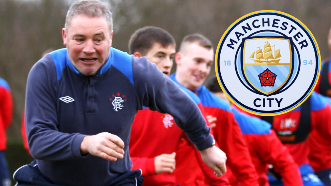 Ally McCoist running at Rangers training in 2012 with the Manchester City crest on the right side