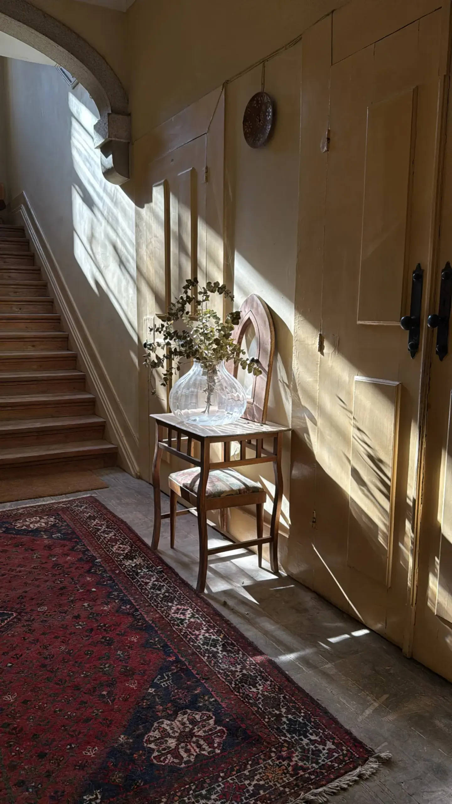 Image may contain Architecture Building Foyer Indoors Home Decor Rug Desk Furniture Table and Interior Design