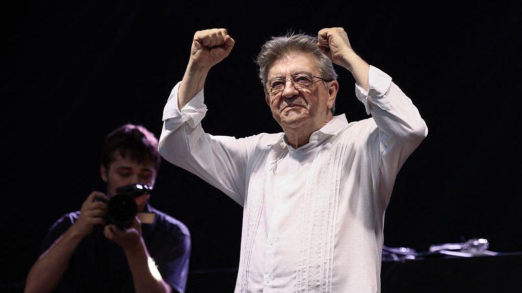 Jean-Luc Melenchon, wearing a white shirt, arrives on stage during a concert as part of the annual street music festival Fete de la Musique in Paris on 21 June 2026.