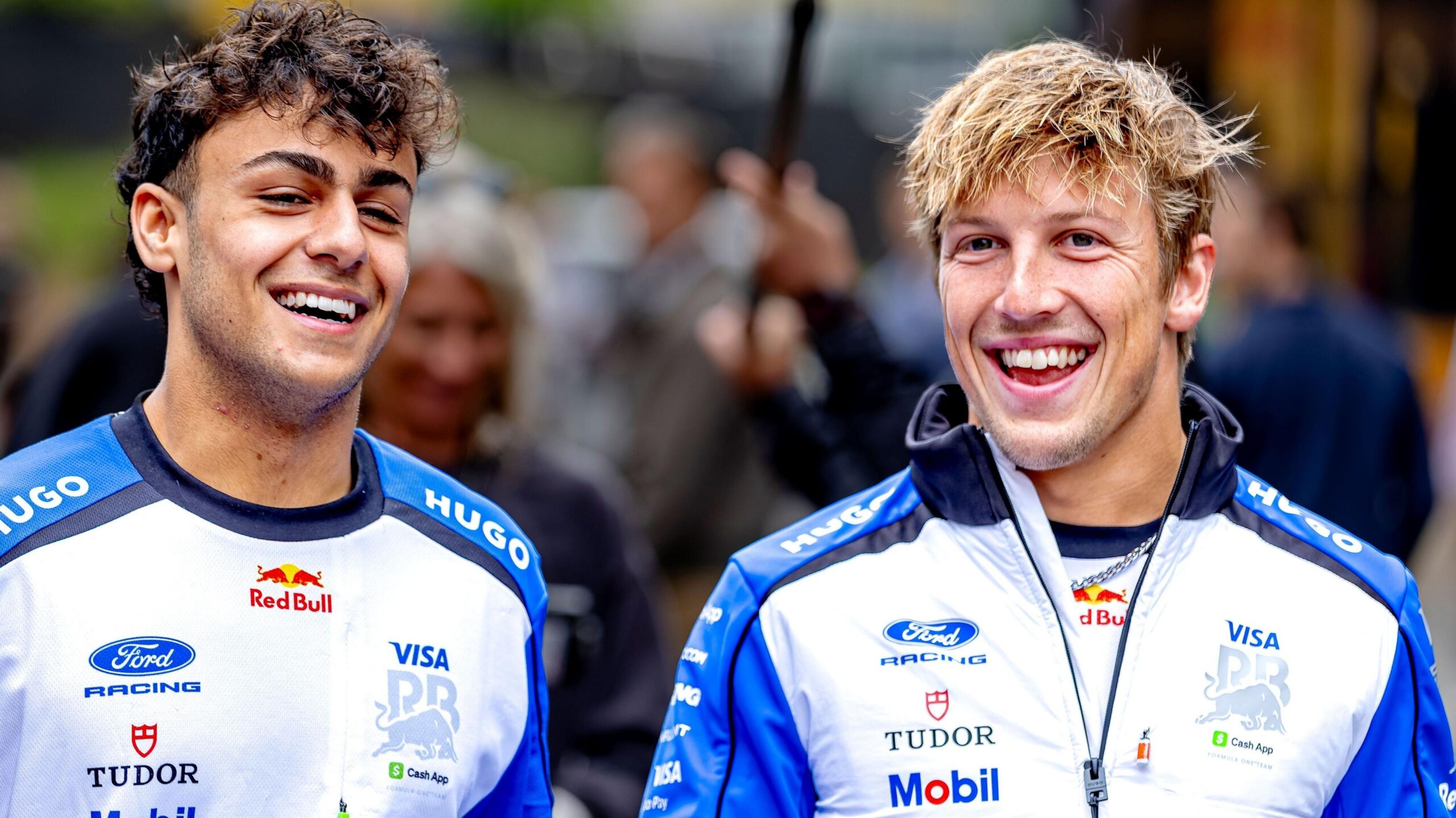 Racing Bulls drivers Arvid Lindblad and Liam Lawson while walking through the paddock at the 2026 Belgian Grand Prix