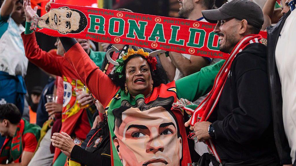 A fan with a Cristiano Ronaldo jumper and scarf