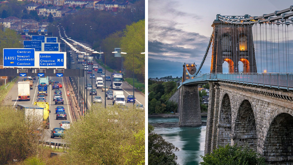 A shot of the M4 on the left, with cars visible on both sides of the motorway, and the Menai Bridge on the right hand side.