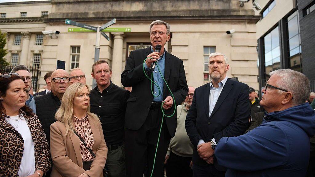 Breandán Mac Cionnaith of the Garvaghy Road Residents' Coalition gives an update to residents after the High Court granted a temporary injunction blocking the controversial Orange Order parade