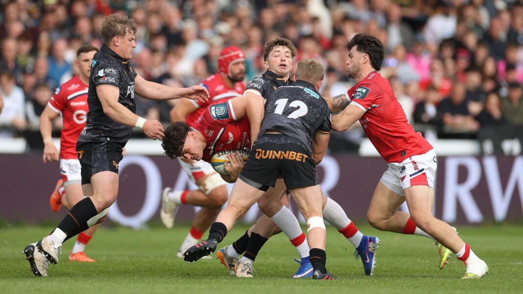 WRU loses £18m and says four regions unsustainable Ospreys players in black jerseys and shorts tackle Scarlets players in red jerseys and white shorts