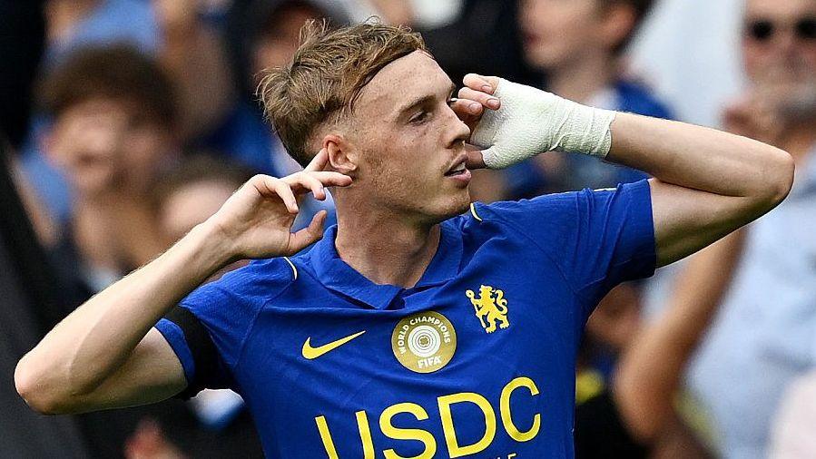 Cole Palmer puts his fingers to his ears after scoring for Chelsea