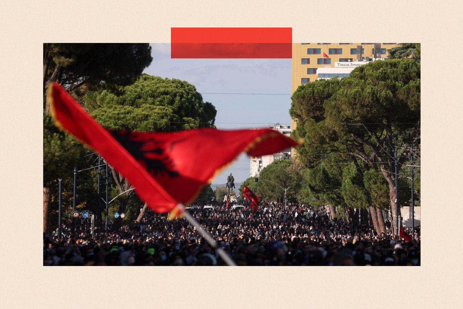 A person waves an Albanian flag as a crowd of demonstrators gathers near the Skanderbeg Monument during an anti-government protest by students in Tirana, Albania, October 24, 2026. REUTERS/Valdrin Xhemaj TPX IMAGES OF THE DAY