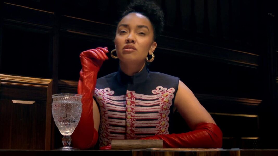 Celebrity Traitors – paranoia deepens as traitor behaviour splits opinion Leigh-Anne Pinnock wearing a military-style top and red long gloves, sitting at the round table