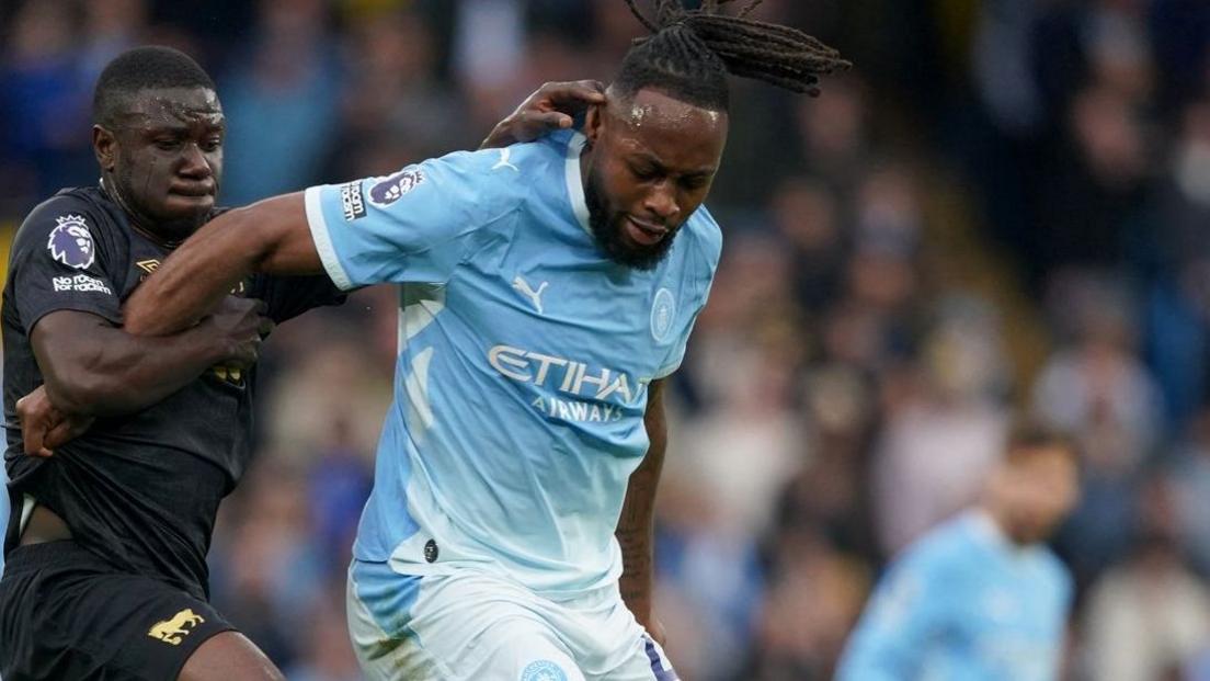 Manchester City's Antoine Semenyo being challenged for the ball
