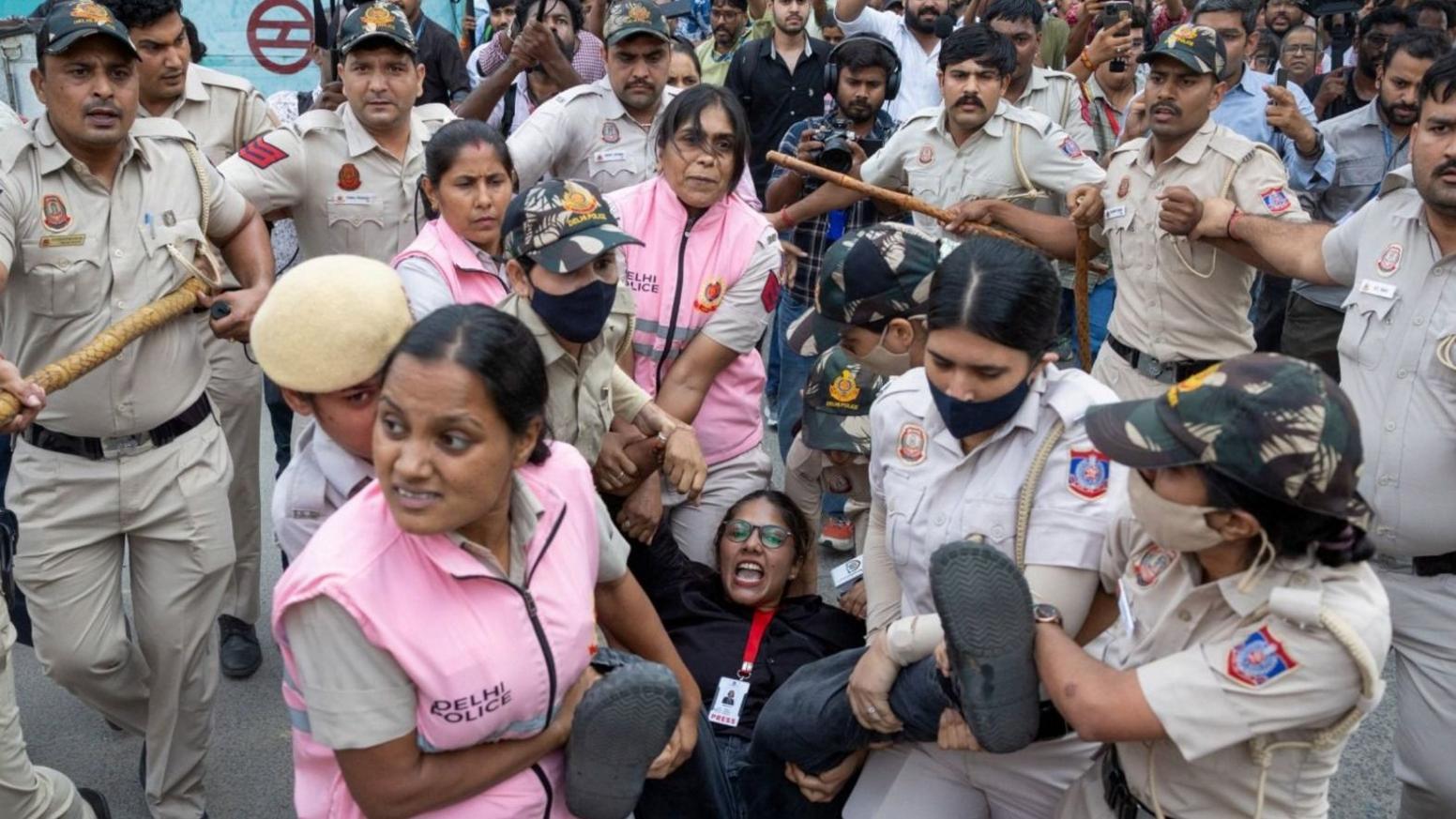 Security personnel and police detain a journalist during a protest by the Cockroach Janta Party (CJP) seeking the resignation of India's Chief Election Commissioner Gyanesh Kumar, near the protest site in New Delhi, India, October 11, 2026. REUTERS/Adnan Abidi
