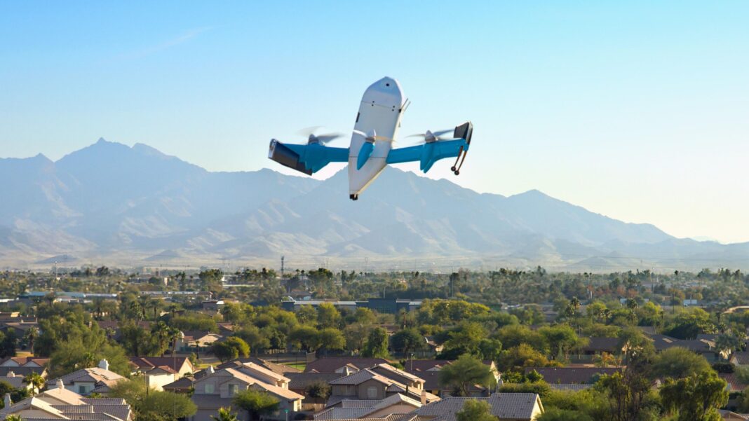 ‘An annoying buzz’: The search for stealthier drones An Amazon drone flies over an US city. In the background are mountains and a blue sky.