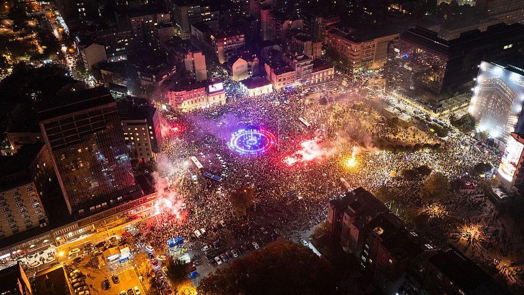 An aerial photo shows supporters of the Students' List gather at the Slavija square as they celebrate their victory in the Serbian parliamentary elections, in Belgrade on October 25, 2026.