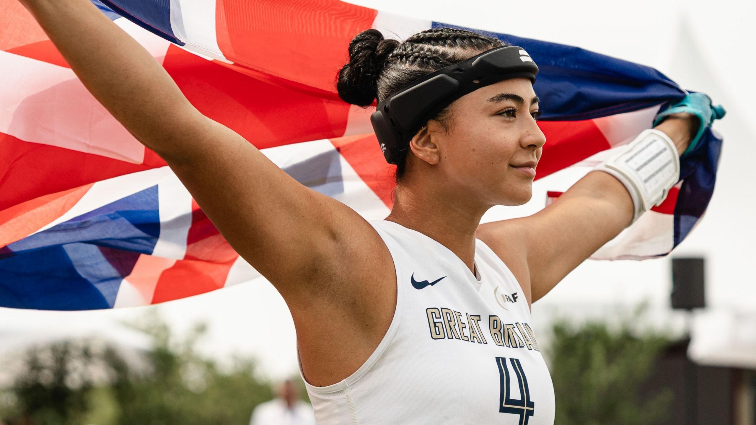 Angelica Tait holds a Great Britain flag aloft during the 2026 Flag Football World Championships
