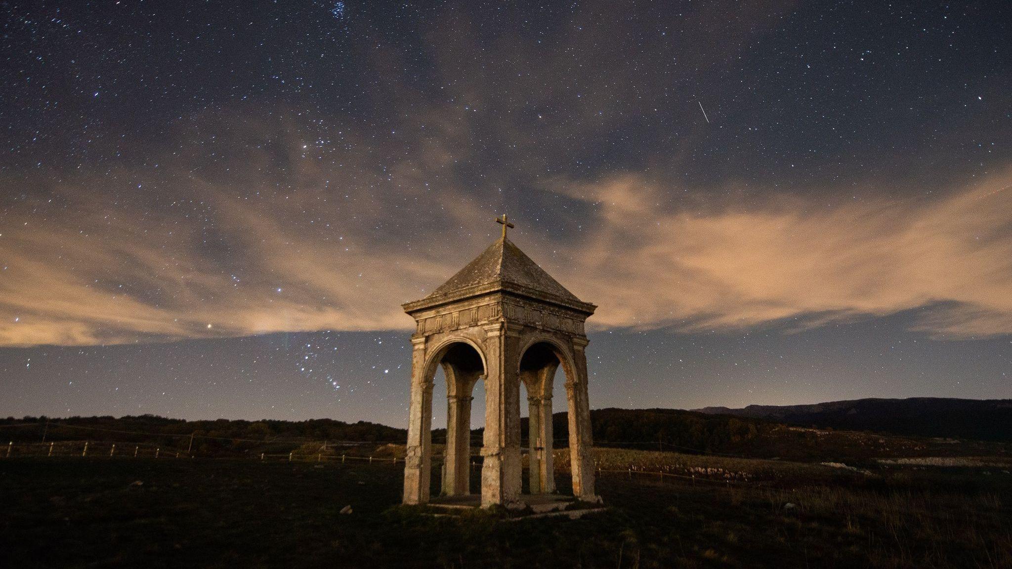 Orionids seen in the night sky passing above Palco della Rimembranza in Terranera, Abruzzo, Italy