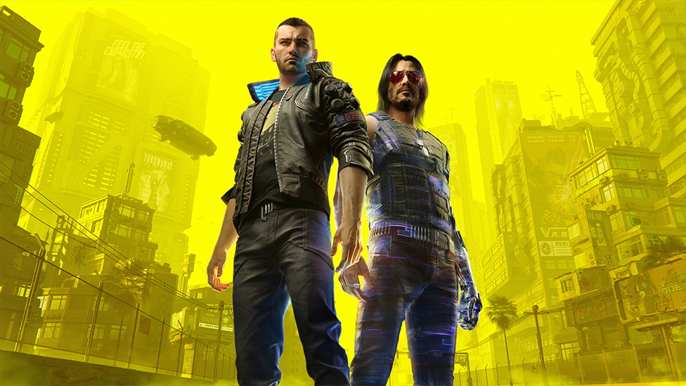Artwork from Cyberpunk 2077 shows player character V - a shaven-headed male wearing a leather jacket over a graphic t-shirt. He's standing next to Johnny Silverhand, who bears the likeness of Keanu Reeves. He's got black, shoulder-length hair and wears a leather, protective vest with matching trousers. He has a silver, cybernetic left arm. The camera is tilted slightly upwards, and the background opens to reveal a panaroma of futuristic flying vehicles and skyscrapers, overlaid with a bright yellow filter.
