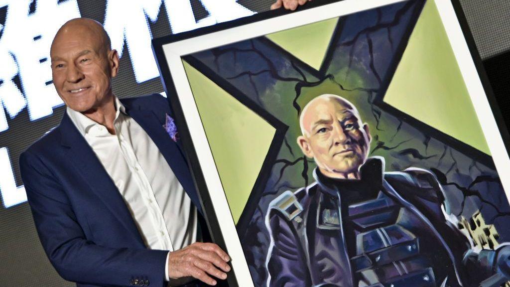 Patrick Stewart poses for photos with a depiction of him as Professor X in the X-Men series