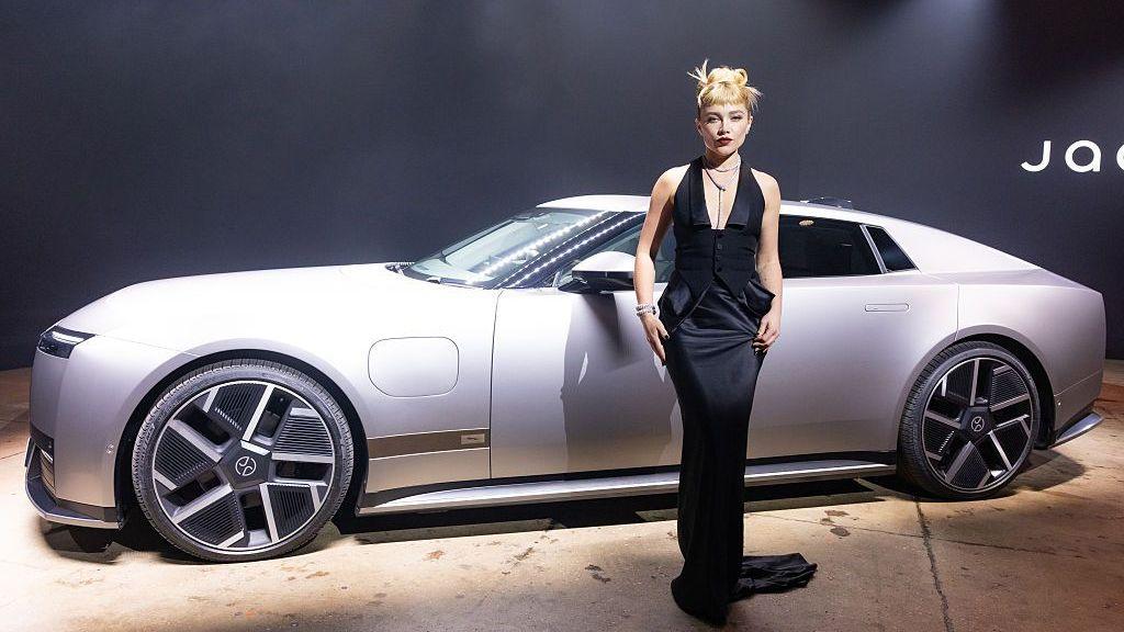 Florence Pugh poses next to a Jaguar Type 01 during the car's launch event at Storied NYC on October 06, 2026 in New York City.