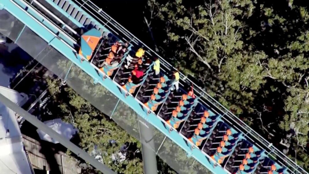 One dead and several hurt after rollercoaster incident at Six Flags Riders are helped off a roller coaster at Six Flags in Georgia.