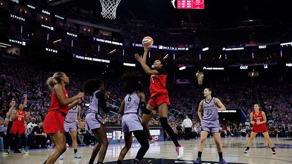 Angel Reese jumps towards the basket