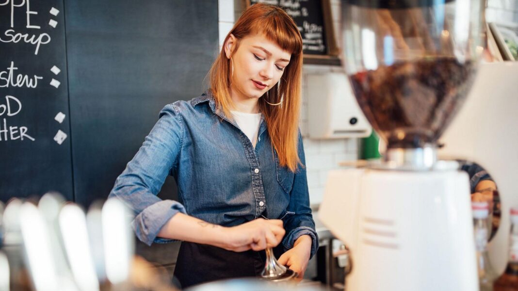 Minimum wage set to rise but 18-20 year-olds will not get bigger increase A young female wearing a denim shirt making coffee in a coffe shop
