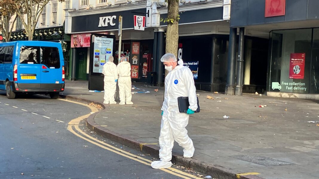 People dressed in white forensics uniforms