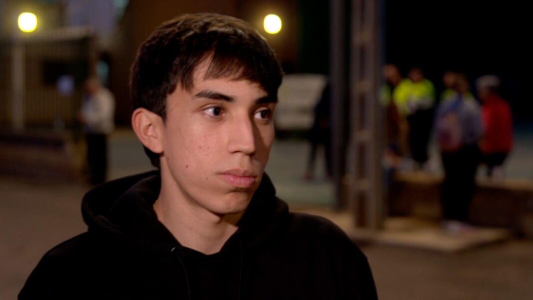Young athlete and former minister among victims of Spain train crash A young man with a black hoodie giving an interview